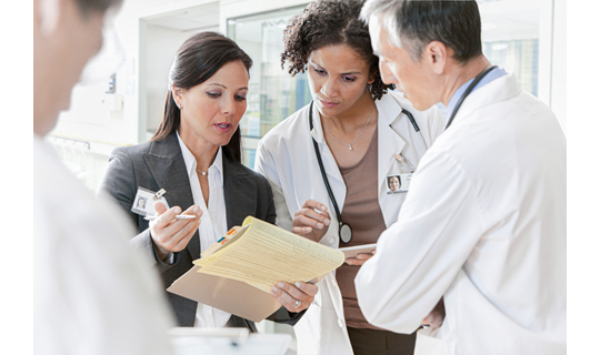 Intrinsiq_Specialty_Solutions_MIPS_consultant_speaking_with_group_of_doctors
