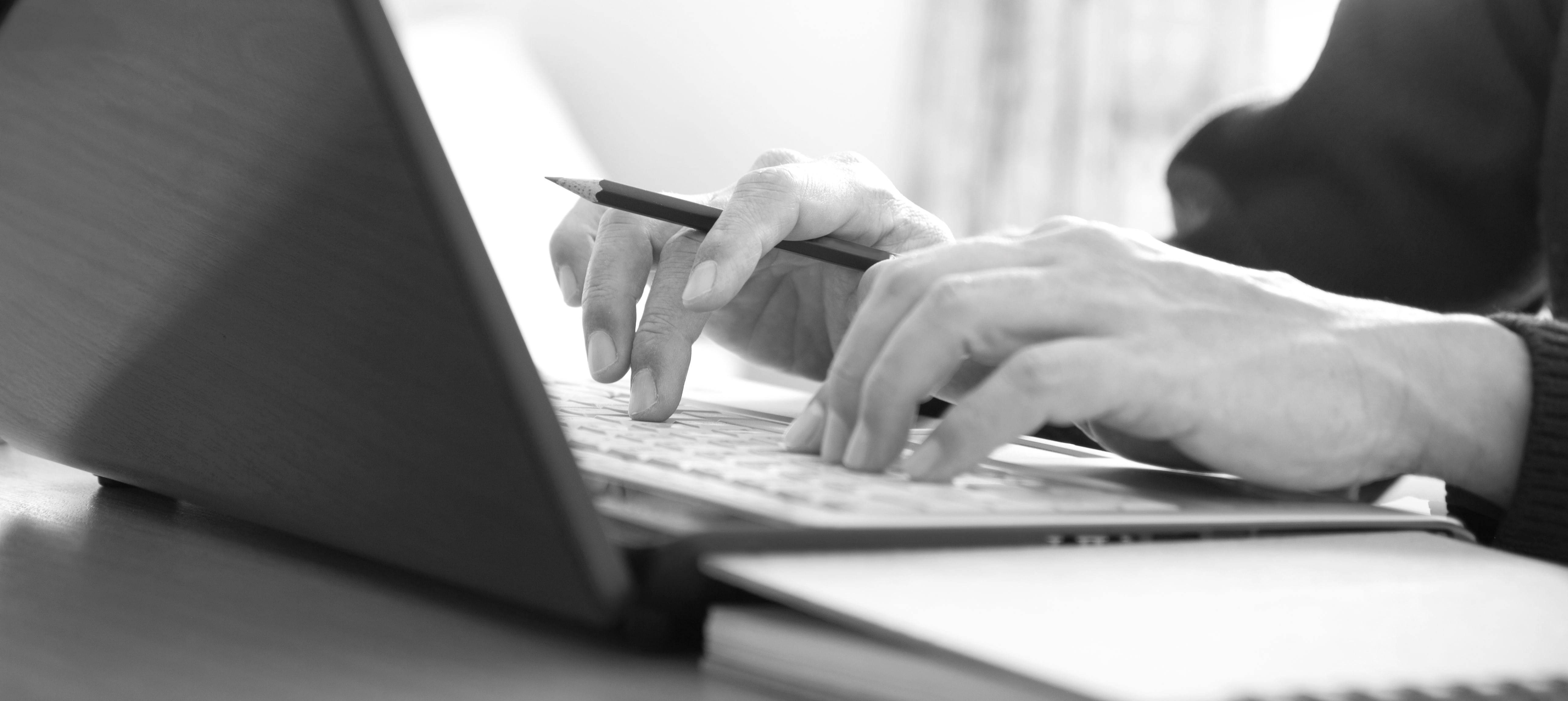 Closeup of hands typing on a laptop computer